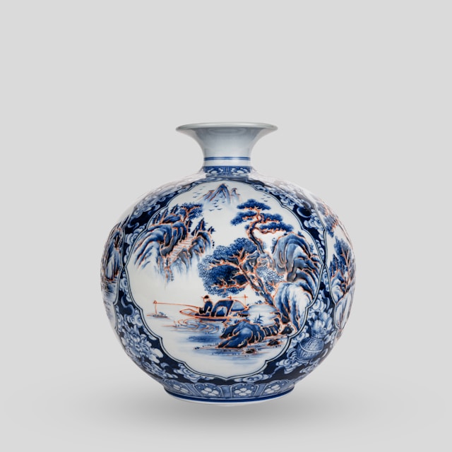 A blue and white vase sitting on top of a table A blue and white vase sitting on top of a table